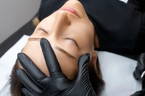 A beautician prepares a client for a procedure to apply henna to eyelashes at the Maris salon in Gdynia.