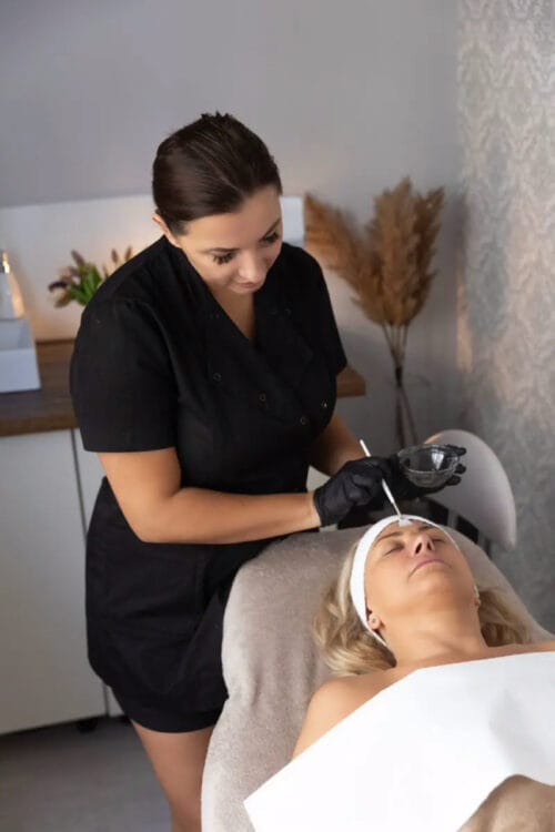 beautician Joanna applies acids to client's face
